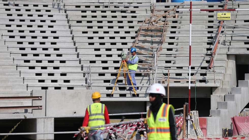 epa08083068 Construction workers at Lusail  Stadium during a media tour in Doha, Qatar, 20 December 2019. Lusail Stadium is one of the eight stadiums build for the FIFA World Cup 2022 in Qatar.  EPA/ALI HAIDER