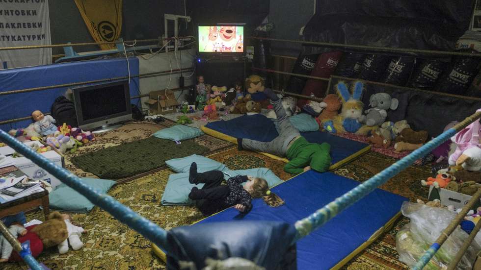 epa10390815 Locals with children attend a shelter and heating point organized in a former boxing club at a basement in the city of Bakhmut, Donetsk area, Ukraine, 04 January 2023 (issued 05 January 2023). Heavy fighting is taking place in the region. Russian troops entered Ukraine on 24 February 2022 starting a conflict that has provoked destruction and a humanitarian crisis.  EPA/GEORGE IVANCHENKO