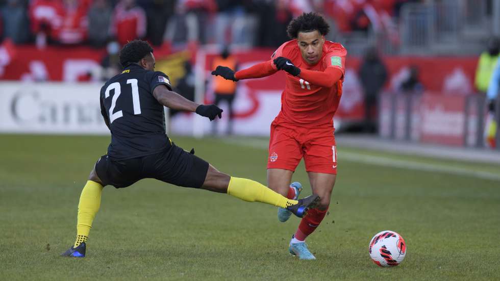 epa09853719 Defender Javain Brown (L) of Jamaica fouls forward Tajon Buchanan of Canada during their soccer match in the final rounds of the Concacaf FIFA World Cup 2022 qualifiers in Toronto, Canada, 27 March 2022.  EPA/WARREN TODA