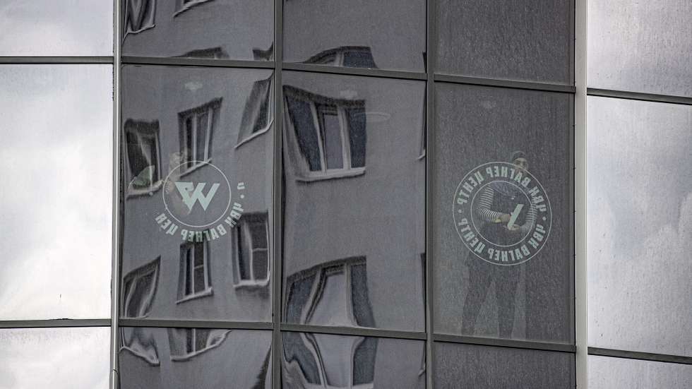 epa10722702 Workers remove the logo of the private military company (PMC) Wagner Group from the windows of the Sea Capital (Morskaya Stolitsa) business center, where Yevgeny Prigozhin's company rented several floors in St. Petersburg, Russia, 02 July 2023. On 23 June 2023, Wagner Group forces led by Prigozhin left the frontline in Ukraine and staged an 'armed mutiny' against Russia's military leadership. Prigozhin claimed on 24 June 2023 that his troops had occupied the headquarters of the Southern Military District in Rostov-on-Don, Russia, a key city near the Ukrainian border. A deal negotiated by the Belarusian president with Prigozhin stopped the Wagner forces' movement toward Moscow and ended the standoff, with Prigozhin and his fighters leaving the country.  EPA/ANATOLY MALTSEV