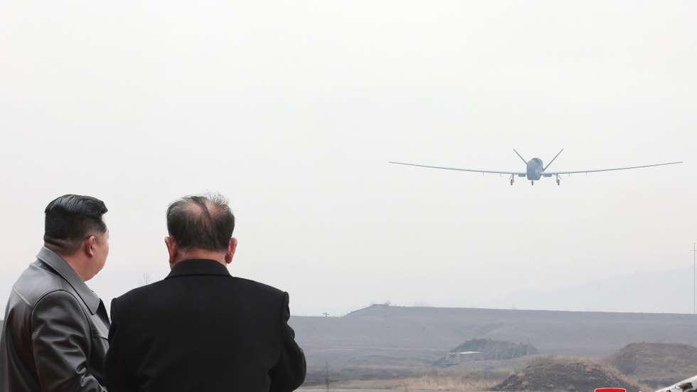 epa11990956 An undated photo released by the official North Korean Central News Agency (KCNA) on 27 March 2025 shows North Korean leader Kim Jong Un (L) inspecting what appears to be a large reconnaissance drone at an undisclosed location in North Korea. According to state media KCNA, Kim reviewed newly developed reconnaissance and suicide drones by the Unmanned Aeronautical Technology Complex and an electronic warfare research group, and oversaw their performance test on 25-26 March 2025.  EPA/KCNA  EDITORIAL USE ONLY