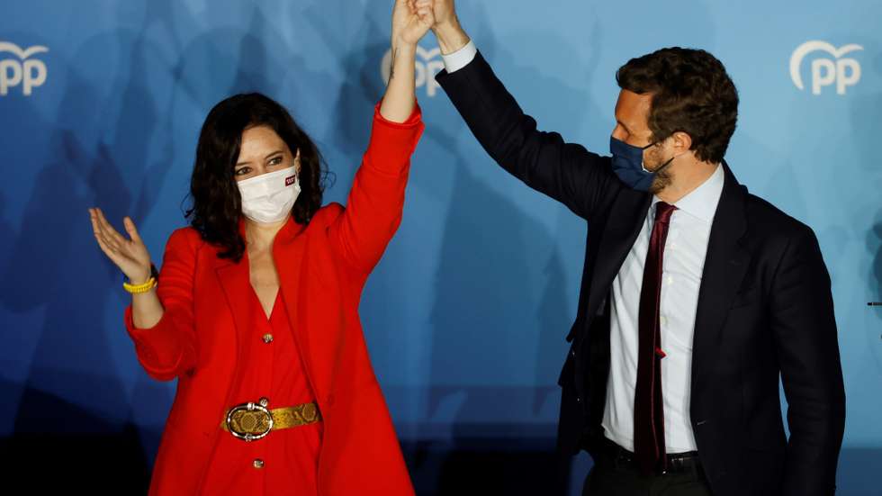 epa09177947 Madrid's regional president and candidate to reelection Isabel Diaz Ayuso (L) and People's Party Part Leader Pablo Casado react as they wait for Madrid's regional elections results closing to the party's headquarters in Madrid, central Spain, 04 May 2021. Isabel Diaz Ayuso could be reelected with between 62 and 65 deputies but would need the support of far-right Vox to form a governmet, according Spanish media.  EPA/Mariscal
