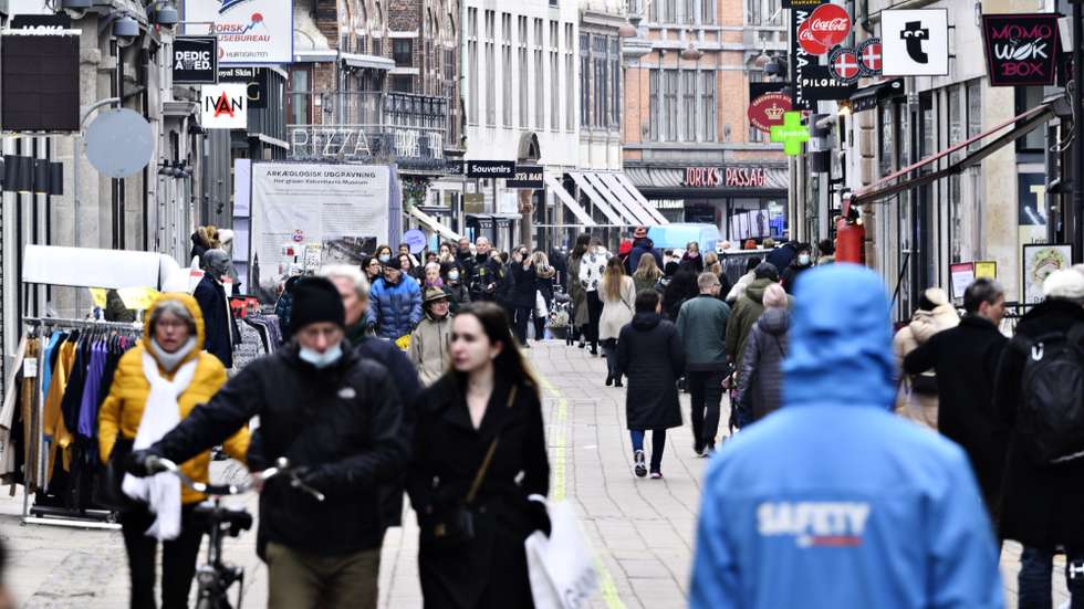 epa09044629 People walk in front of shops that reopen on famous pedestrian street Stroeget in the center of Copenhagen, Denmark, 01 March 2021. The shops closed due to fears of covid-19 infections are reopening after Denmark eases pandemic restrictions.  EPA/PHILIP DAVALI  DENMARK OUT
