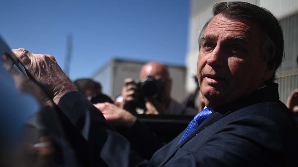 epa10704202 Former president of Brazil, Jair Bolsonaro, leaves the Federal Senate after visiting his son Senator Flavio Bolsonaro at the National Congress in Brasilia, Brazil 21 June 2023. The Superior Electoral Court (TSE) will begin a trial on 22 June for alleged abuses of power by former Brazilian President Jair Bolsonaro, who may lose all his political rights if found guilty.  EPA/Andre Borges