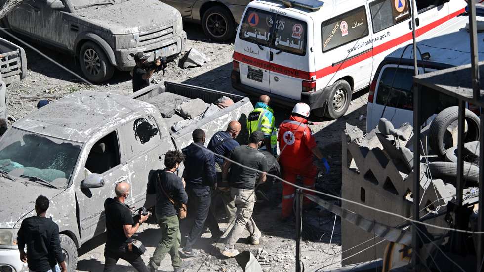 epa11674540 Members of the emergency services carry a body recovered at the site of an Israeli military strike near the Rafik Hariri University Hospital (RHUH), in the Jnah District of Beirut, Lebanon, 22 October 2024. At least 13 people were killed after an Israeli airstrike near Lebanon's largest public hospital in southern Beirut, the Lebanese Ministry of Health said. According to the latter, more than 2,400 people have been killed and over 11,600 others have been injured in Lebanon since the start of recent escalations of hostilities.  EPA/WAEL HAMZEH