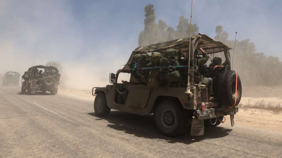 epa12118914 Israeli soldiers on military vehicles move towards the southern Gaza Strip border near Khan Yunis, seen from southern Israel, 20 May 2025. Israel's military continued to strike targets across the Gaza Strip as part of its 'Gideon's Chariots' operation.  EPA/ATEF SAFADI