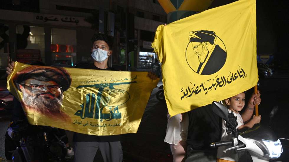 epa12355447 Supporters hold Hezbollah flags as they rally to protest against the Lebanese government's endorsement of a plan to disarm the militant group, in a southern suburb of Beirut, Lebanon, 05 September 2025. The Lebanese government endorsed the army's plan to disarm Hezbollah in a cabinet meeting on 05 September.  EPA/WAEL HAMZEH