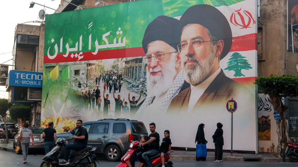 epa13047619 A billboard features portraits of Iran's new Supreme Leader Ayatollah Mojtaba Khamenei (R) and his father, the late Supreme Leader Ayatollah Ali Khamenei (L), with a statement 'Thank you Iran' during Muharram in the southern suburbs of Beirut, Lebanon, 18 June 2026. Shiite Muslims across the world are observing the holy month of Muharram, the first month of the Islamic calendar, which culminates with the celebration of the Ashura festival, commemorating the martyrdom of Imam Hussein, a grandson of the Prophet Muhammad, in the Iraqi city of Karbala in the seventh century.  EPA/WAEL HAMZEH