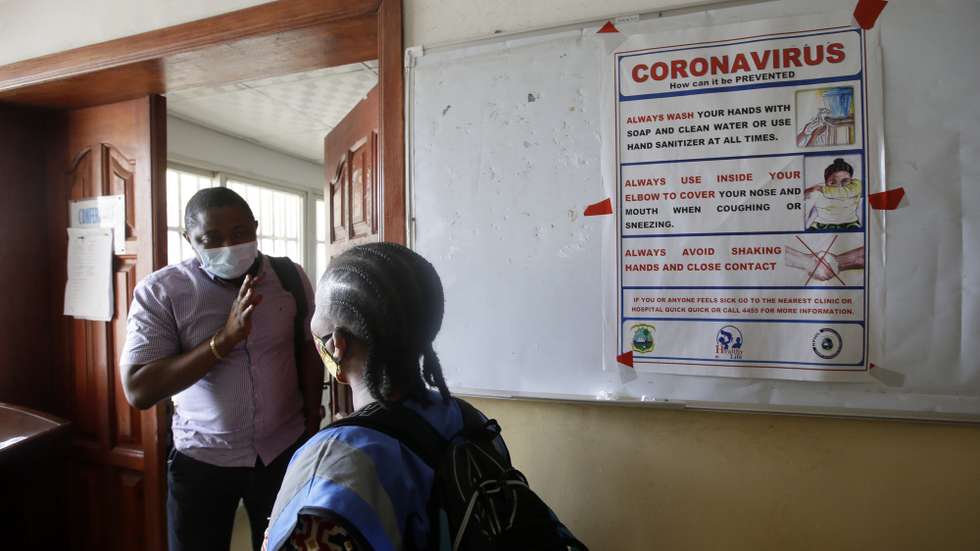 epa08388023 People walk past a bulletin carrying messages of Coronavirus prevention measures at the Health Ministry, Monrovia, Liberia, 27 April 2020. The Liberian government has ordered compulsory wearing of face masks in an effort to curb the spread of COVID-19 Pandemic in the country. Liberia health authorities announced that the Attorney General and Minister of Justice, has been tested positive for COVID-19. On 10 April, the government of Liberia has announced a state of emergency for 21 days and a nationwide quarantine, as measures the widespread of the SARS-CoV-2 coronavirus which causes the Covid-19 disease.  EPA/AHMED JALLANZO