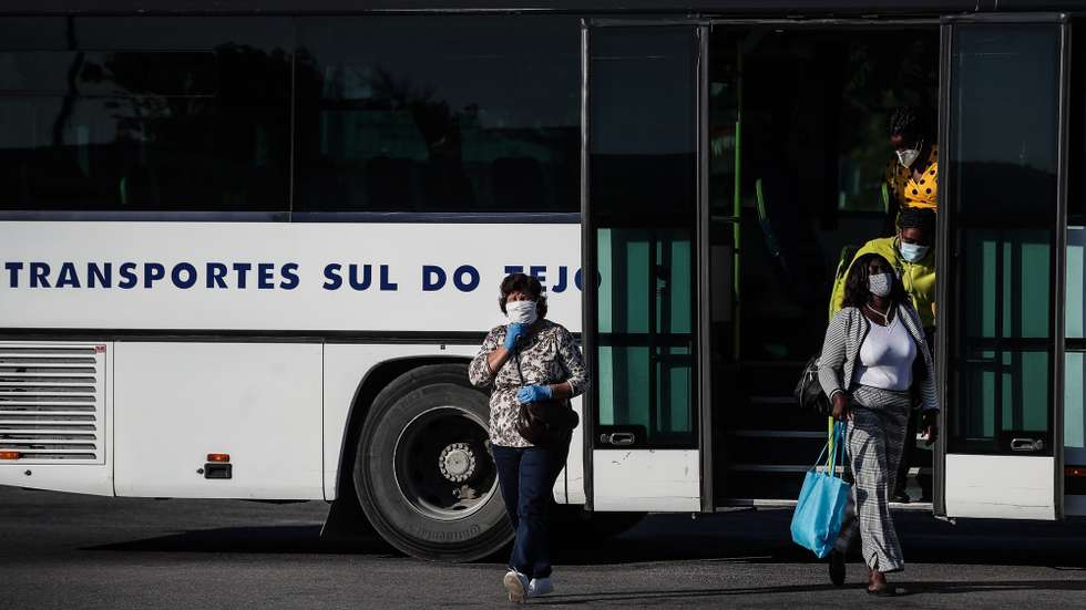 Utentes à saída de um autocarro dos Transportes Sul do Tejo (TST), em Cacilhas, Almada, 20 de maio de 2020. O transporte rodoviário foi reforçado com a entrada do segunda fase do desconfinamento devido à pandemia da covid-19, apesar disso as carreiras continuam com poucas pessoas o que contrasta com a grande utilização dos transportes fluviais da Transtejo/Soflusa. (ACOMPANHA TEXTO). MÁRIO CRUZ/LUSA