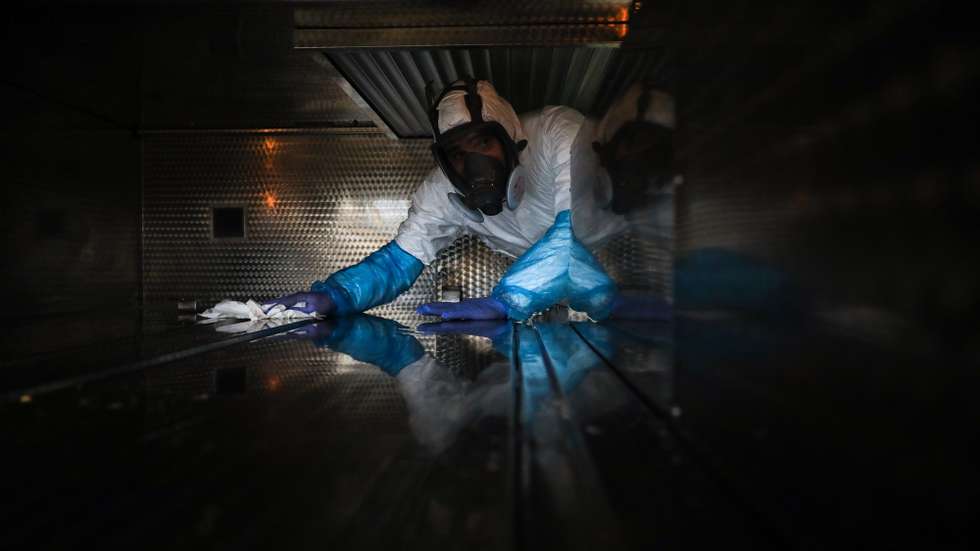 epa08347895 An employee of a funeral home fully protected with a protective suit against radioactive contamination and biological agents, disinfecting a vehicle to transport the body of a man over 80 years old who died in his home as a victim of covid-19, in Lisbon, Portugal, 03 April 2020 (Issued 07 April 2020). Portugal is in state of emergency until 17 April 2020. Countries around the world are taking increased measures to stem the widespread of the SARS-CoV-2 coronavirus which causes the Covid-19 disease.  EPA/MIGUEL A. LOPES  ATTENTION: This Image is part of a PHOTO SET