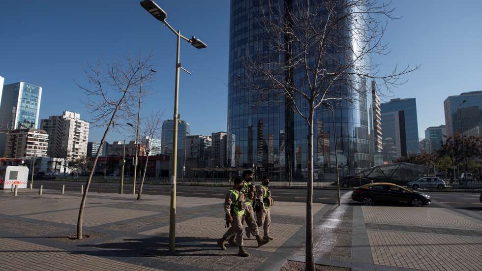 epa08571225 Military are seen during a patrol on an empty street in the Las Condes district in Santiago, Chile 28 July 2020. Around 1.3 million people today saw their lockdown lifted in the metropolitan area of Santiago de Chile and in the neighboring coastal region of ValparaÃ­so due to the decrease in the number of infections and deaths from COVID-19 registered in those areas of the country.  EPA/Alberto Valdes