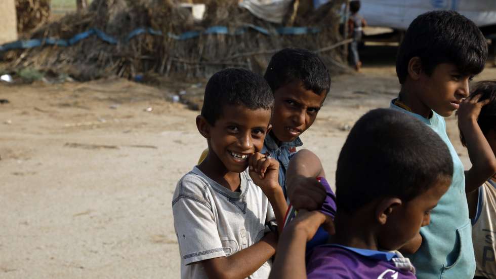 epa08659545 Yemeni children gather outside their families' huts in the western town of Abs, Yemen, 06 September 2020 (Issued 10 September 2020). According to UNICEF's recent report, around 5.8 million Yemeni children are actually out of school due to the prolonged conflict, their families' large economic hardship and the coronavirus COVID-19 pandemic.  EPA/YAHYA ARHAB