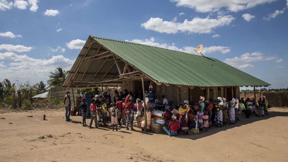 Mães com os seus filhos aguardam pela consulta de uma brigada móvel do Fundo das Nações Unidas para a Infância (UNICEF), um grupo de profissionais de saúde que viaja de ambulância e vai ao encontro das comunidades mais afastadas em vez de esperar por elas em centros de saúde, Impire, Moçambique, 24 de julho de 2020. Em menos de uma hora, na povoação de Impire, distrito de Metuge, sul de Cabo Delgado, juntam-se dezenas de mães com as suas crianças - a maioria ainda bebés - para a brigada observar, com pesagem, medição de altura, avaliação à subnutrição, seguindo-se uma consulta, vacinação e entrega da medicamentos numa rotina que inclui a observação das mães e decorre desde manhã até o sol se pôr, num pavilhão empoeirado. (ACOMPANHA TEXTO DE 25 DE JULHO DE 2020). RICARDO FRANCO/LUSA