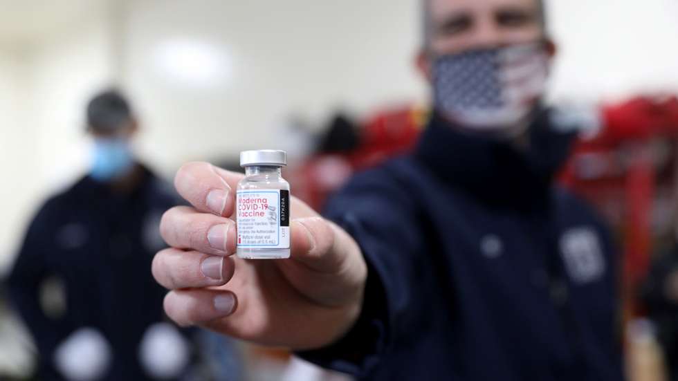 epa08908574 Mayor of Los Angeles Eric Garcetti holds a vial of the Moderna COVID-19 vaccination while personnel of the Los Angeles Fire Department (LAFD) receive the vaccine at LAFD Station 4 in Los Angeles, California, USA, 28 December 2020. Mayor of Los Angeles Eric Garcetti and Ralph M. Terrazas, Fire Chief of the Los Angeles Fire Department, were there to observe the rollout of the vaccination program.  EPA/Gary Coronado / POOL