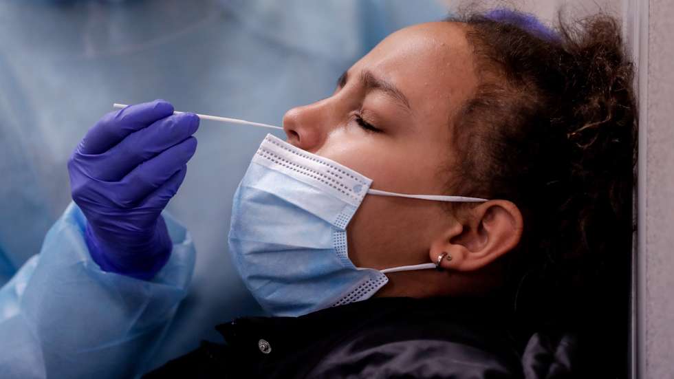 epa08966666 A nurse examines a test for COVID-19 at a testing center run by the Belgian Red Cross in Brussels, Belgium, 26 January 2020.  EPA/STEPHANIE LECOCQ