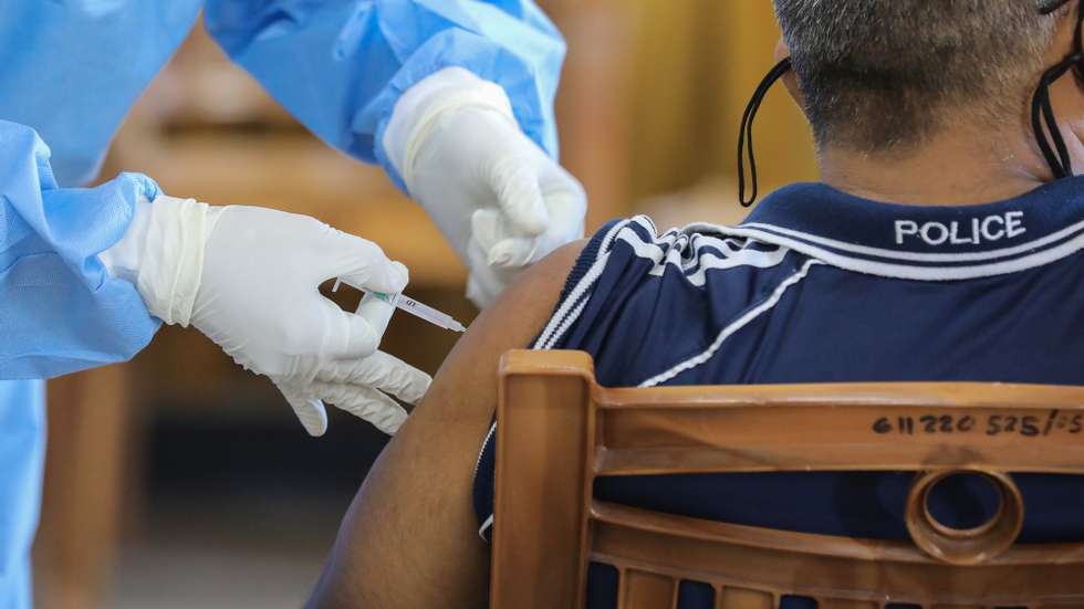 epa08976614 A police officer receives the first dose of the Oxford-AstraZeneca COVID-19 vaccine at the Police Hospital in Colombo, Sri Lanka, 31 January 2021. Sri Lankan health authorities started the COVID-19 vaccination drive for frontline workers on 29 January, after receiving 500,000 doses of the Oxford-AstraZeneca COVID-19 vaccine from neighboring India.  EPA/CHAMILA KARUNARATHNE