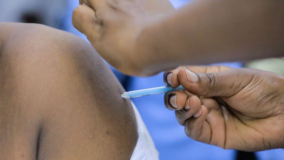 epa09053819 A Kenyan healthcare worker gets vaccinated with an Oxford/AstraZeneca COVID-19 vaccine dose during the official launch of vaccinating health workers at the Kenyatta National Hospital (KNH) in Nairobi, Kenya, 05 March 2021. Kenya on 03 March received its first batch of 1.02 million doses of Oxford/AstraZeneca COVID-19 vaccines through global COVAX scheme prioritizing to vaccinate healthcare workers, teachers and people with compromised immunity. Kenya is expected to import 24 million doses in a couple of months.  EPA/DANIEL IRUNGU