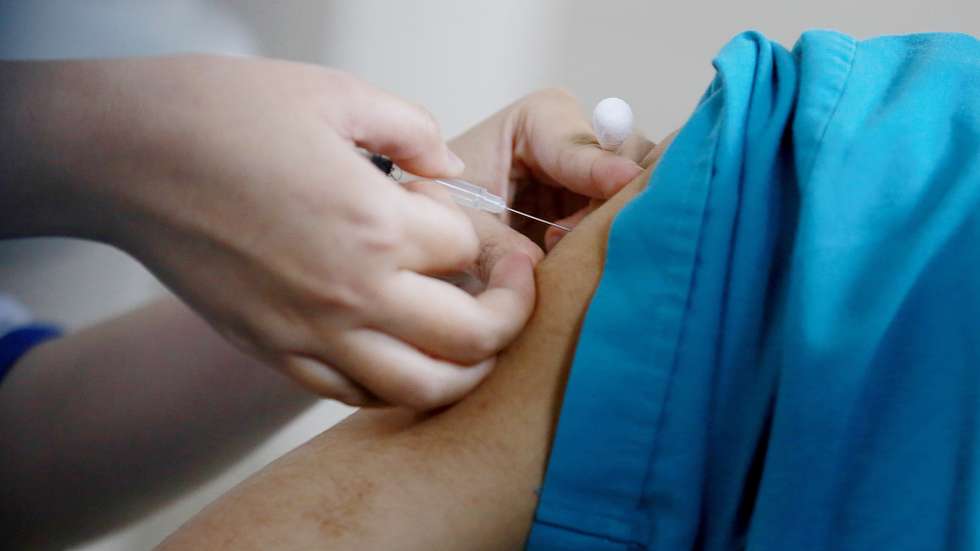 epa09063120 A medical worker receives a shot of COVID-19 vaccine at Thanh Nhan hospital in Hanoi, Vietnam, 09 March 2021. Vietnam launched its COVID-19 vaccination campaign on 08 March, after receiving the first batch of AstraZeneca vaccine which were manufactured in South Korea and imported by Vietnam Vaccine Company (VNVC) in February.  EPA/LUONG THAI LINH