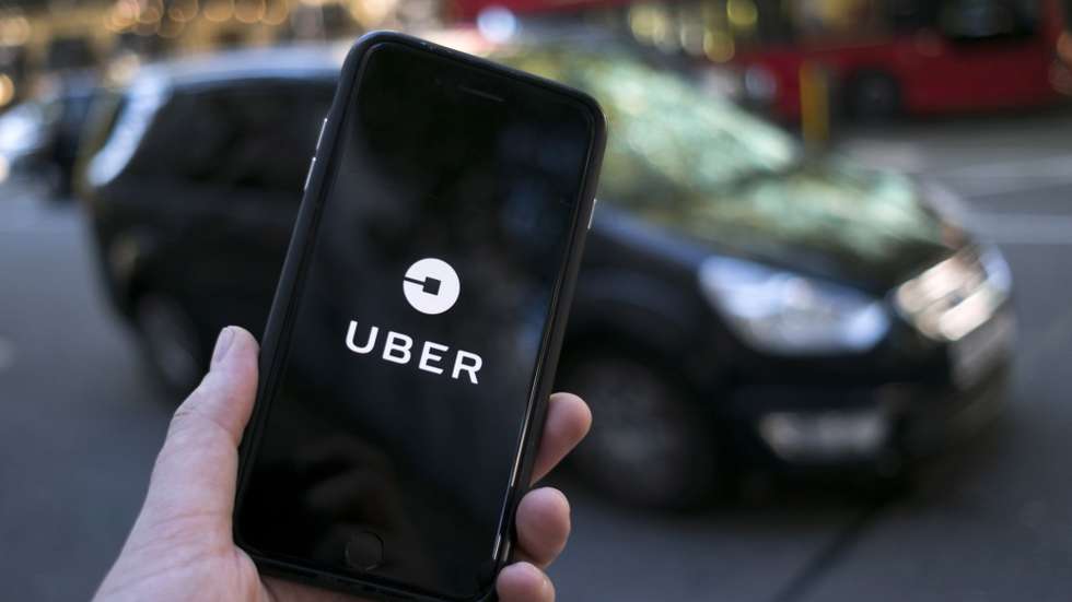 epa09023553  (FILE) - An Uber logo on a mobile telephone in central London, Britain, 22 September 2017 (re-issued 19 February 2021). The UK Supreme Court on 19 February 2021 ruled the Uber drivers are not not self-employed but workers. Uber, that has some 45,000 drivers working in London and that lost earlier court cases, said it would contact its active drivers across UK and discuss the operations. The ruling could mean Uber drivers may be entitled to holiday payments and minimum wages.  EPA/WILL OLIVER *** Local Caption *** 55660504