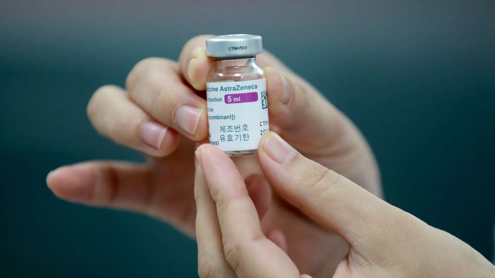 epa09079043 A health worker holds a vial of COVID-19 vaccine developed by AstraZeneca at a vaccination center of the Vietnam Vaccine Joint Stock Company (VNVC), in Hanoi, Vietnam 17 March 2021. Major European countries have temporarily suspended the use of the AstraZeneca jab following reports of side effects such as blood clots.  EPA/LUONG THAI LINH