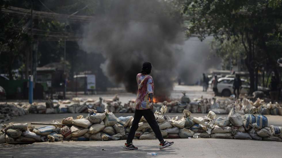 epaselect epa09100781 A demonstrator walks along a barricade during a protest against the military coup in Yangon, Myanmar, 27 March 2021. Anti-coup protests continue as Myanmar's junta held a military parade in a major show of strength for the annual Armed Forces Day on 27 March in Naypyitaw.  EPA/STRINGER
