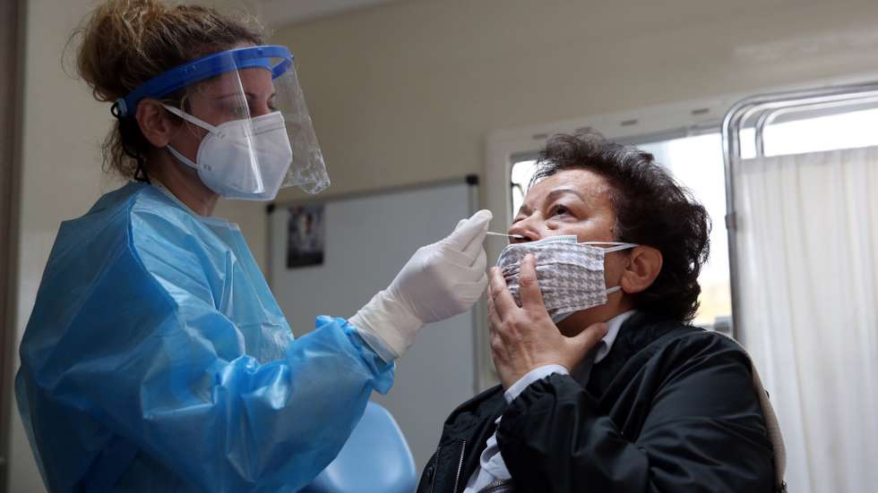 epa09116613 A woman gets a rapid test on the first day of retail stores re-opening, in Athens, Greece, 05 April 2021. The stores reopened after several weeks of closure due to restrictions against the spread of the Covid-19 pandemic.  EPA/ORESTIS PANAGIOTOU