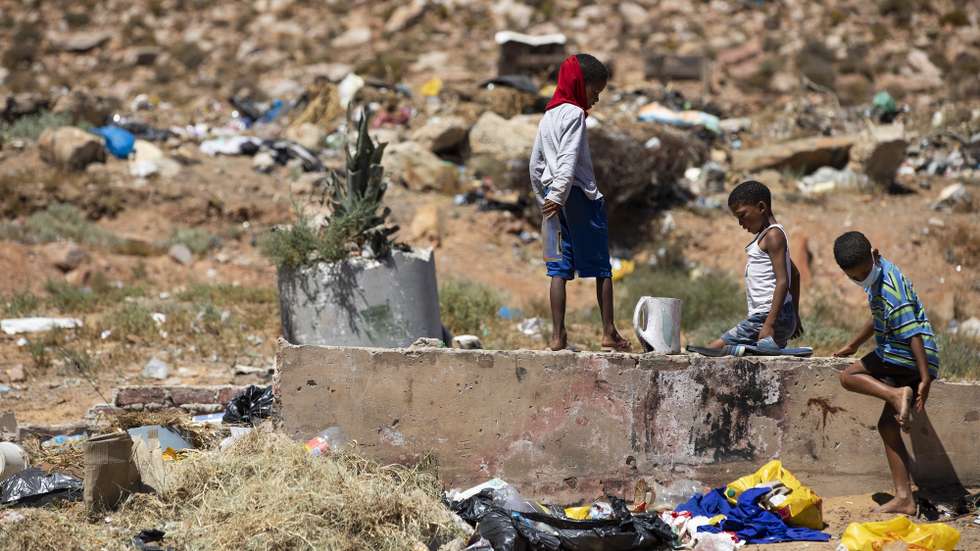epa08998852 Children scrounge useful items from a rubbish dump in an area that is a beneficiary of the Compassionate Hearts soup kitchen in Touws River, an old railway town labelled as the doorway to the Karoo, situated along the R62 wine route in the Western Cape of South Africa, 09 February 2021. Touws River has a 93 percent unemployment rate, according to humanitarian organisation Gift of the Givers Foundation. In the last year during the lockdowns for the pandemic the majority of the town's residents have become unemployed with what few businesses existed now closed. The old railway town used to have employment in the form of mostly farm workers and the Commuter Transport Engineering (CTE) factory, a main source of employment for residents but have since been laid off due to the economic crisis from the pandemic lockdowns. Many residents are desperate and rely on aid for survival with homelessness and severe poverty rife due to the economic downturn. The town has become a ghost town with very few people ever stopping there from the passing national highway. There is no government Home Affairs or Labour Department offices for the unemployed to access services such as the Unemployment Insurance Fund in Touws River. The Compassionate Hearts soup kitchen does not receive funding and is appealing for help.  EPA/NIC BOTHMA ATTENTION: This Image is part of a PHOTO SET