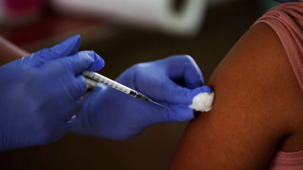 epa09168654 A person receives the first dose of the Pfizer vaccine against covid-19, at the Victoria D'Spinaym school, in La Chorrera, Panama, 29 April 2021. A new batch, the twelfth, with 78,390 doses of the Pfizer covid-19 vaccine arrived on 28 April,  in Panama, which will continue with the vaccination of people over 60, pregnant women and teachers.  EPA/Bienvenido Velasco