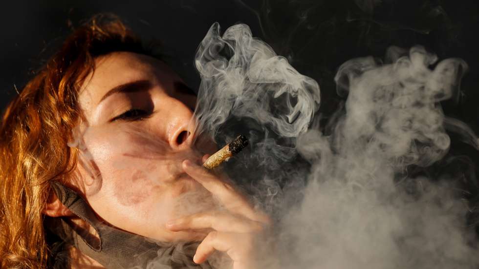 epa08830198 A person smokes marijuana during a demonstration in favor of the drugs legalization and regulation, in Guadalajara, Jalisco, Mexico, 19 November 2020. On 19 November, the Mexican Senate approved legalizing adult-use recreational marijuana.  EPA/Francisco Guasco