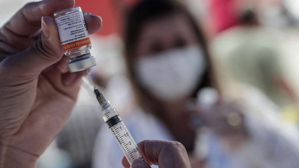 epa09105059 A health professional prepares a vaccine against Covid-19, in the city of Duque de Caxias, Brazil, 29 March 2021. The mayor of the city reported that anyone older than 65 years will be able to get vaccinated, which caused thousands of people to wait in long lines to receive the Coronavac vaccine against COVID-19.  EPA/Antonio Lacerda