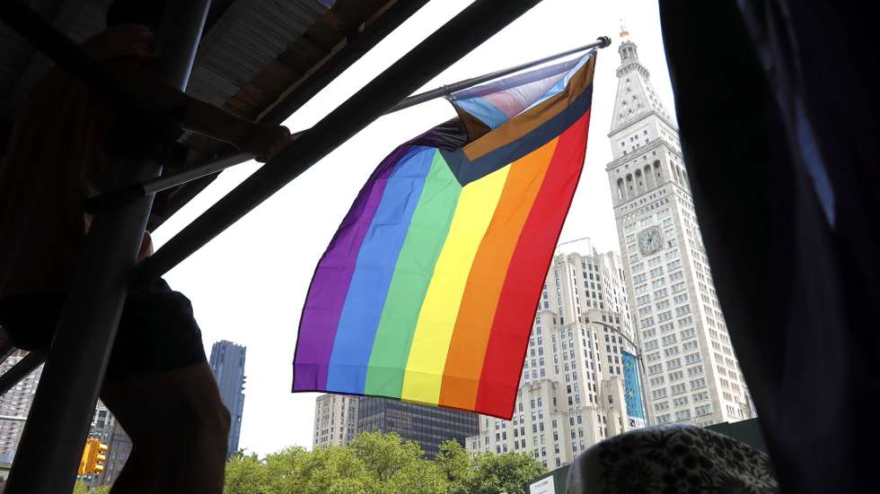 epa09306415 A spectator waves a gay pride flag at the 52nd annual New York City Gay Pride Parade, in New York, New York, USA, 27 June 2021. The theme for NYC Pride 2021 is appropriately titled 'The Fight Continues', and it refers to several national and local concerns, including police brutality, state anti-LGBT legislation, and economic hardship.  EPA/Peter Foley