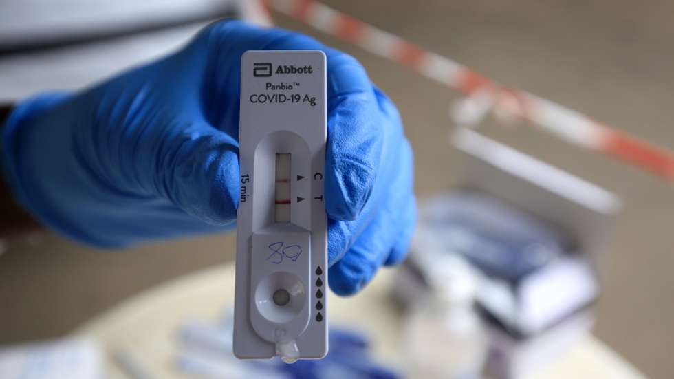 epa09328332 A nurse shows a positive Covid-19 test result during a testing of members of the public at Parirenyatwa Hospital in Harare, Zimbabwe, 07 July 2021. The country has been hit by the Delta variant and this has resulted in a huge demand for the frst dose of the Covid-19 vaccine.  EPA/AARON UFUMELI