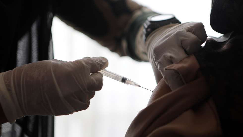 epa09378615 A woman receives a dose of Sinovac vaccine during a COVID-19 mass vaccination for locals in Banda Aceh, Indonesia, 30 July 2021. Indonesia is speeding up its vaccination campaign for people aged 12-18 and above due to an increasing number of coronavirus disease (COVID-19) cases as Indonesian authorities also extended restrictions on emergency community activities (PPKM) until 02 August 2021.  EPA/HOTLI SIMANJUNTAK