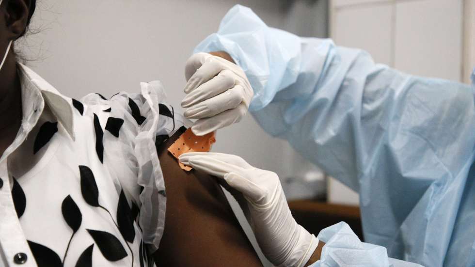 epa09416997 An Ivorian woman receives the first injection of the vaccine against the Ebola virus, in a vaccination center at the University Hospital of Cocody in Abidjan, Cote d'Ivoire, 16 August 2021. Ivorian ministry of health confirmed on 14 August a patient tested positive with the Ebola virus after travelling to Abidjan from the neighboring Guinea, the first Ebola case reported in the Ivory Coast in 25 years. Health authorities began disinfecting the premises of the Cocody hospital, where the patient was first admitted, and vaccinating health workers against Ebola.  EPA/LEGNAN KOULA