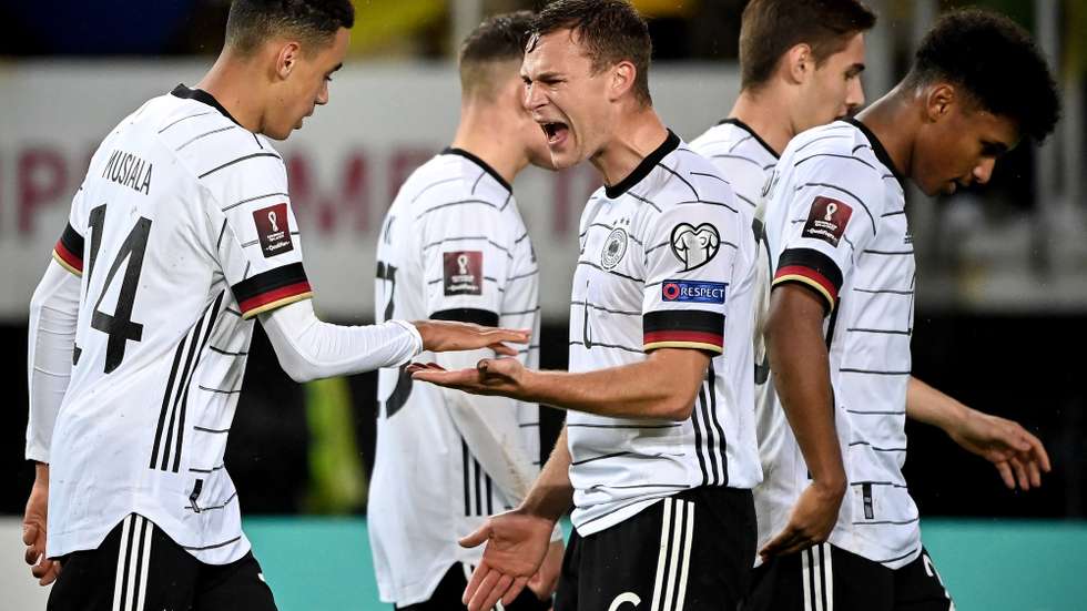 epa09519247 Germany's Jamal Musiala (L) celebrates with his teammate Joshua Kimmich (C) after scoring the 4-0 lead during the FIFA World Cup Qatar 2022 qualifying Group J soccer match between North Macedonia and Germany in Skopje, Republic of North Macedonia, 11 October 2021.  EPA/GEORGI LICOVSKI