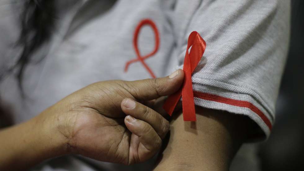 epa08037311 Princy Mangaika, Executive Director of Positive Women's Network (PWN), herself an HIV infected patient and another female make AIDS awareness ribbons at her residence in Colombo, Sri Lanka 01 December 2019. Mangalika, a mother of two acknowledges that she contracted the Human Immunodeficiency Virus (HIV) in 1999 from her spouse who had worked overseas and identified as positive in 2000, and says that those in her village had set their home on fire when they became aware of their illness. Without giving up hope, she has continued to assist in awareness-raising and also runs a care center for several AIDS patients. Currently, her organization WomenÕs Network (PWN) has 586 members including 44 children. Several events were held in Colombo to coincide with World AIDS Day on 1st December. The estimated number of people infected with HIV in Sri Lanka is around 3500 to - 4200 by 2018, but only around two-thirds of them know that they have HIV, according to the National STD/AIDS Control Programme (NSACP) of the Ministry of Health, Sri Lanka. The island nation aims to completely eradicate Human Immunodeficiency Virus (HIV) and the Acquired Immunodeficiency Syndrome (AIDS) by the year 2030.  EPA/Chamila Karunarathne