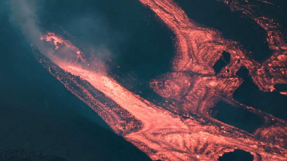 epa09544917 A view of the river of lava expelled by Cumbre Vieja volcano in La Palma, Canary Islands, Spain, late 24 October 2021 (issued 25 October 2021). A new partial collapse of the volcano's cone has increased the river of lava.  EPA/Angel Medina G.