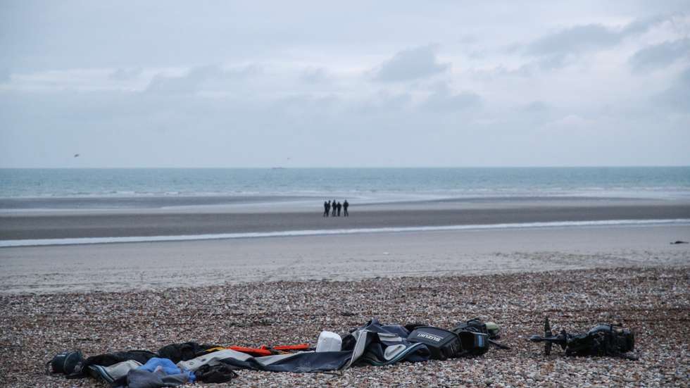 epa09618969 Remains of damaged migrants' inflatable boat and personal belongings left by migrants on the beach near Wimereux, France, 25 November 2021. At least 27 migrants have died and two more were brought to the hospital after the boat they were trying to cross La Manche canal (English Channel) to Great Britain sank.  EPA/MOHAMMED BADRA