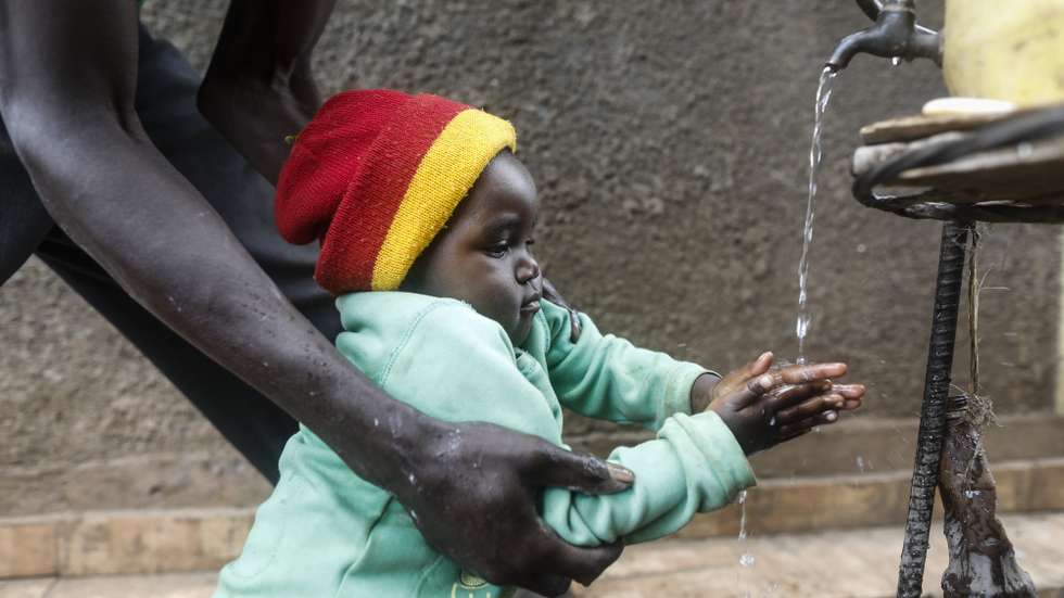 epa06617987 A young boy is helped by his father to wash his hands with tap water at a water collection point in Kibera slum, Nairobi, Kenya, 21 March 2018, ahead of the World Water Day. World Water Day is marked on 22 March every year to bring attention to the importance of water. Residents of Kibera slum on average pay five Kenya shillings (five US cents) per 20 liters of water. The United Nations Children's Fund (UNICEF) estimates only 56 per cent of the country's population has access to safe water while 50 per cent of urban population resides in slums that lack adequate sanitation and hygiene.  EPA/DAI KUROKAWA
