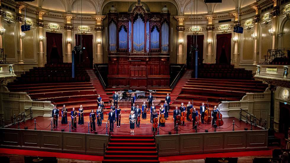 epa08608088 Princess Beatrix (C) stands on the stage in the Concertgebouw after a concert by the European Union Youth Orchestra in Amsterdam, the Netherlands, 16 August 2020.  EPA/ROBIN UTRECHT