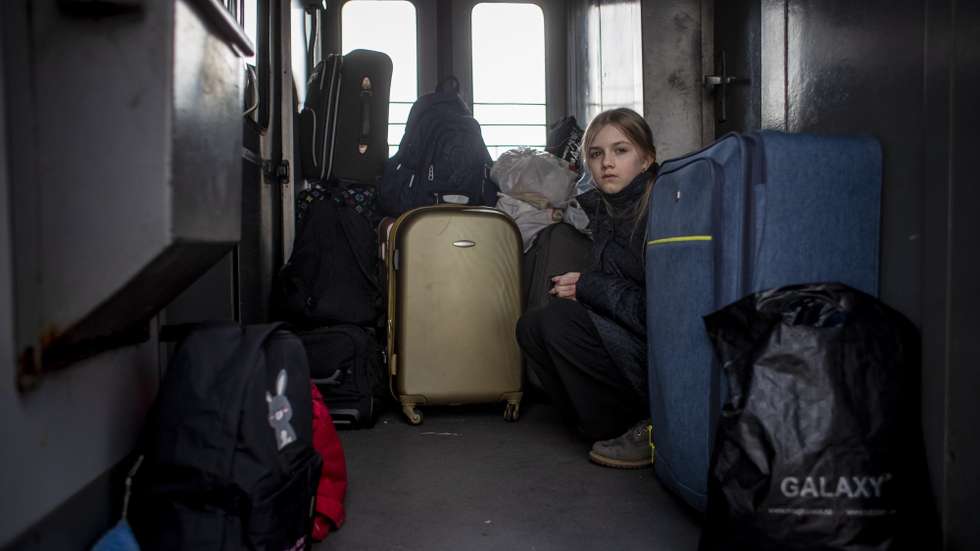 epa09801648 A girl sits on a train with people fleeing Ukraine to Poland by train, in Mostyska, Ukraine, 04 March 2022. According to the United Nations (UN), at least one million people have fled Ukraine to neighboring countries since the beginning of Russia's military aggression on 24 February 2022. The UN estimates that around 160,000 Ukrainians are currently internally displaced.  EPA/MARTIN DIVISEK