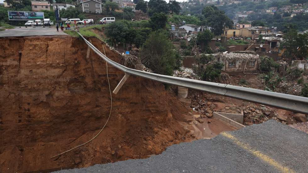 epa09887988 A completely destroyed road with flood debris near Durban, South Africa, 13 April 2022. At least 250 people have died as a result of heavy flooding in the Eastern Coastal area. Key roads in the area have been damaged and mudslides destroyed houses. The South African National Defense Force have been called in to assist as President Cyril Ramaphosa visited the area on 13 April.  EPA/STR