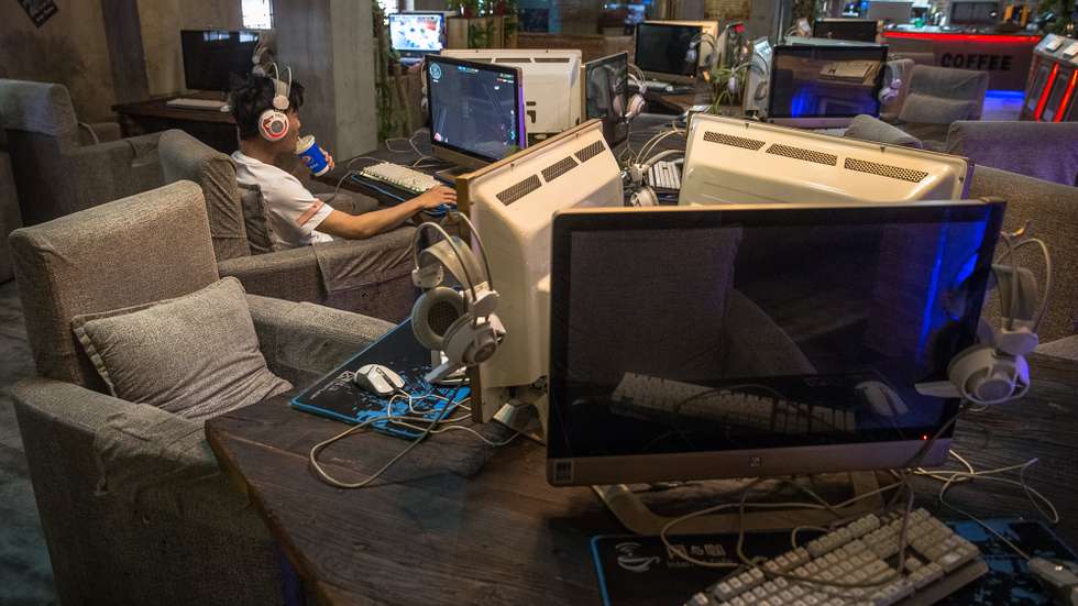 epa06000638 A Chinese man uses a computer at an internet cafe in Beijing, China, 31 May 2017. China will adopt a controversial cybersecurity law from 01 June despite concerns from overseas groups doing business in China. The aim of the law is to protect networks and private user information with rigorous data surveillance and storage for companies and firms working in China.  EPA/ROMAN PILIPEY