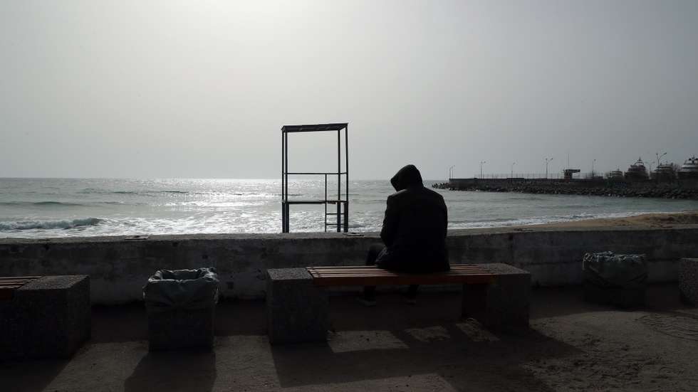 epa09863844 A citizen looks at the sea in an empty beach in Odessa, a city that struggles with a touristic crisis caused by the war, Odessa, Ukraine, 01 April 2022. On 24 February Russian troops had entered Ukrainian territory in what the Russian president declared a 'special military operation', resulting in fighting and destruction in the country, a huge flow of refugees, and multiple sanctions against Russia.  EPA/NUNO VEIGA