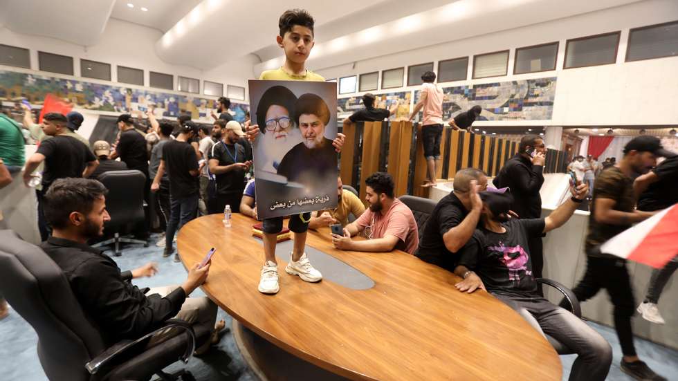 epaselect epa10094672 Supporters of Iraqi Shiite cleric Muqtada al-Sadr, head of the Sadrist movement, gather inside the Iraqi parliament buliding after they stormed the so-called &#039;Green Zone&#039; in central Baghdad, Iraq, 27 July 2022. Protesters loyal to popular Shiite cleric Muqtada al-Sadr breached the heavily fortified Green Zone, home to government buildings and foreign embassies in Baghdad, protesting against a premiership candidate announced by the Coordination Framework earlier this week. The Iraqi Prime Minister called on the demonstrators to withdraw.  EPA/AHMED JALIL