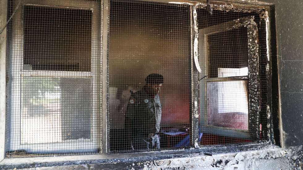 A Mozambique army soldier checks the destroyed Police Station in Palma, Cabo Delgado, Mozambique, 09 April 2021. The violence unleashed more than three years ago in Cabo Delgado province escalated again about two weeks ago, when armed groups first attacked the town of Palma. JOAO RELVAS/LUSA