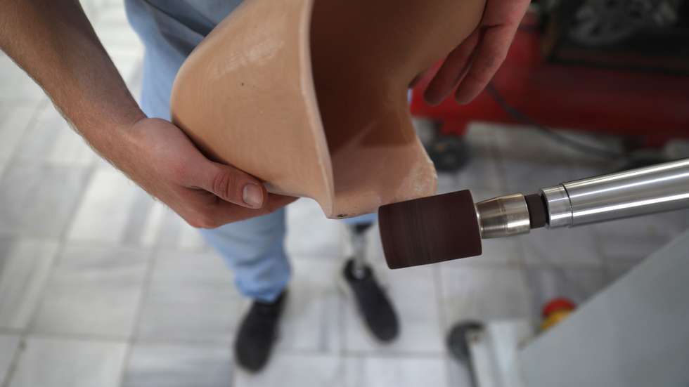 epa08774688 Physiotherapist Abdelmawla Ibrahim works on a prosthetic in al-Bab Centre for prosthetics in Aleppo, Syria, 18 October 2020 (issued 26 October 2020). Ibrahim a 24-year-old Syrian physiotherapist specialised in prosthetics is an amputee himself. Ibrahim had his leg amputated during the Syrian conflict. After getting fitted with a prosthetic leg, he decided to be a physiotherapist and to specialise in prosthetics offering help to other amputees.  EPA/YAHYA NAMEH