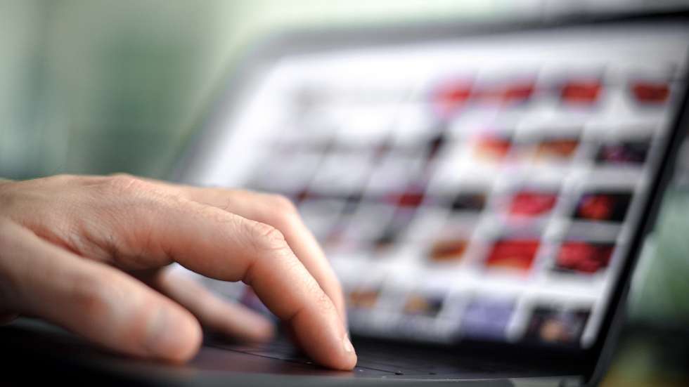 epa08473196 A person sits in front of a computer screen showing many small photos and holds a computer mouse in his hand, in Duisburg, Germany, 08 June 2020. According to the investigators, the case of child sex abuse ring in Muenster, with three victims and eleven suspects, seven of whom are in custody, is characterized by its highly professional technical equipment for video recording and data encryption. Abuse offenders adapt to the possibilities, but also to the dangers of detection and professionalize themselves on the net, according to police investigators. In 2019 there were more than 12,000 investigations and criminal proceedings in Germany for so-called child pornography.  EPA/SASCHA STEINBACH