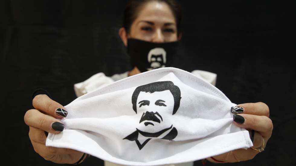 epa08367814 A person holds a face mask, which depicts famed drug lord Joaquin 'El Chapo' Guzmanto, in Guadalajara, Jalisco, Mexico, 16 April 2020. According to media reports, Alejandrina Guzman, daughter of Joaquin 'El Chapo' Guzman, has helped in the distribution of aid and supplies, labelled with the name and image of her father, to members of the public during the outbreak of coronavirus in Mexico.  EPA/Francisco Guasco